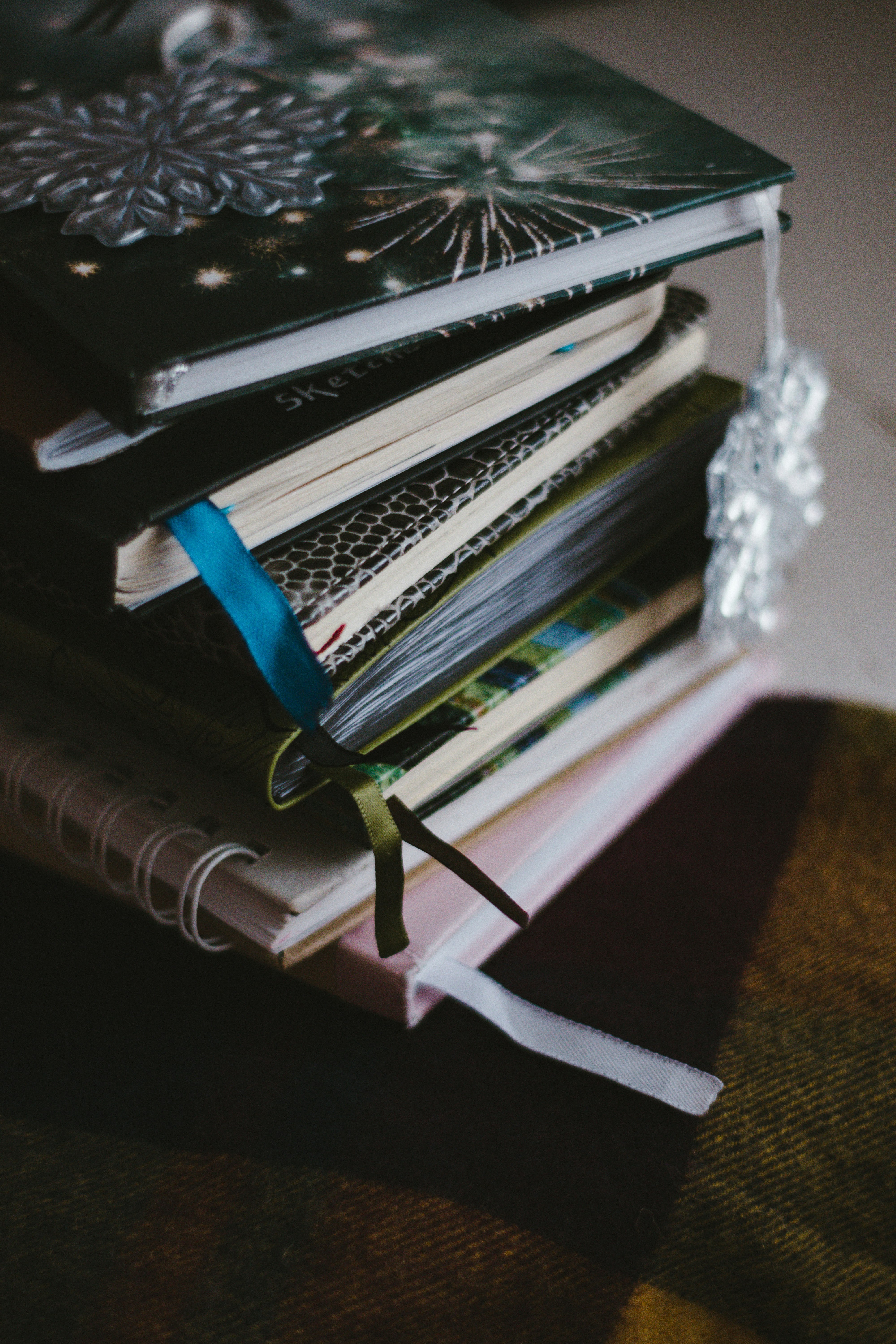 white and blue book on brown wooden table